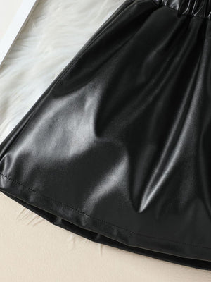 Black faux leather toddler shorts with elastic waistband and ruffled detail.