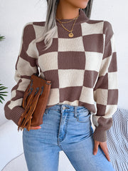Checkerboard knit mock neck pullover sweater in camel and white acrylic with ribbed cuffs and hem.