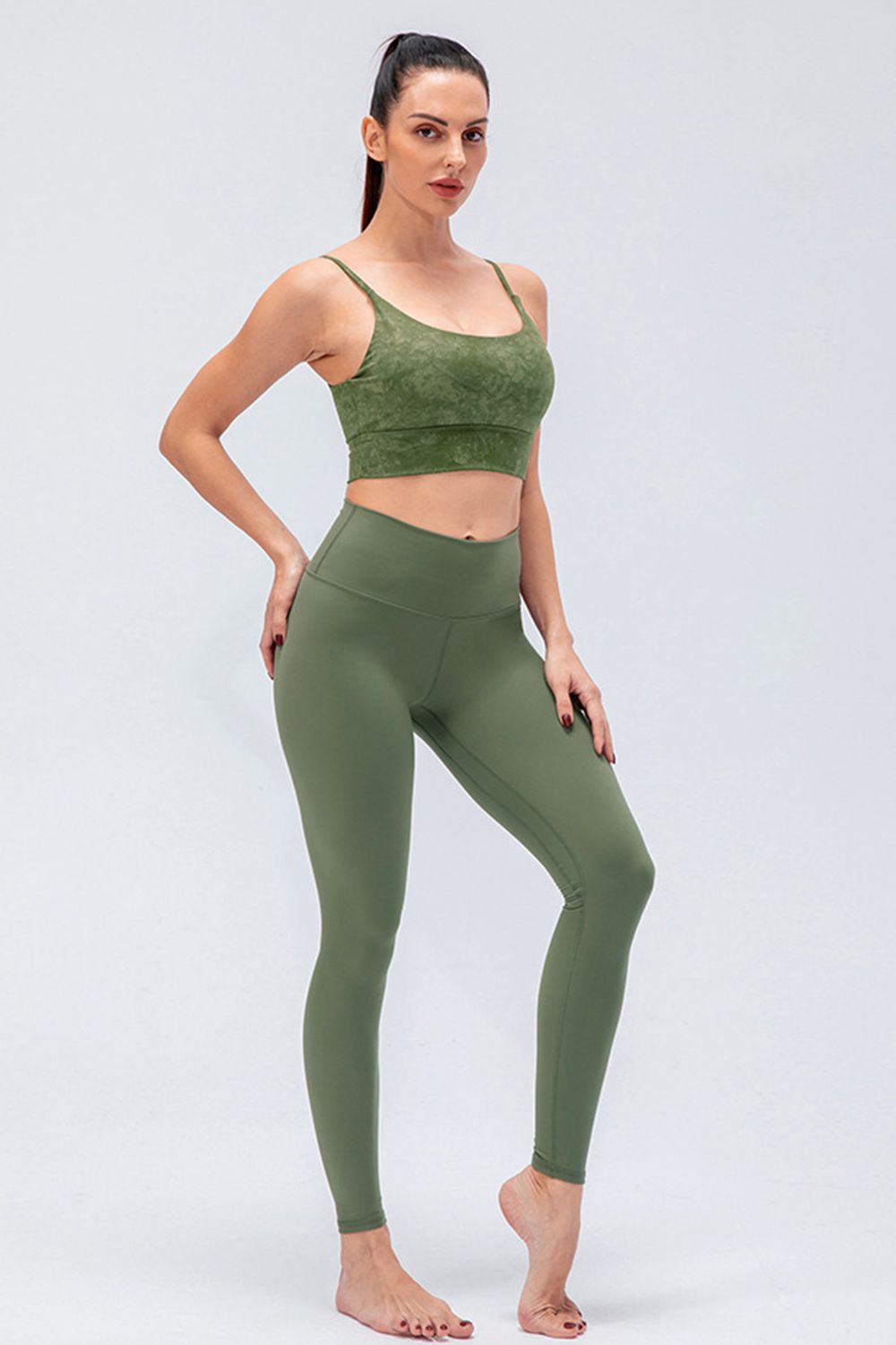 Sculpted olive high-rise performance leggings with a seamless design and full length.