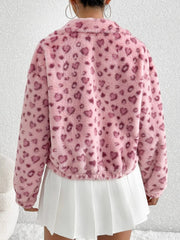 Pink faux fur track jacket with heart print and zip front, styled with a white pleated skirt.