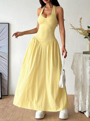 Yellow V-neck ruched maxi dress with empire waist and halter straps