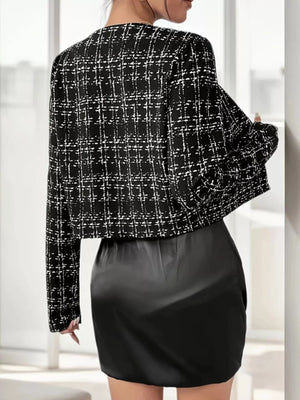 Black tweed cropped jacket with white plaid pattern and long sleeves.