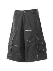 Black distressed maternity cargo capris with multiple pocket details and a plaid patch.