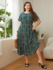 Emerald floral midi dress in deep teal, 100% polyester, with short sleeves and tiered skirt.