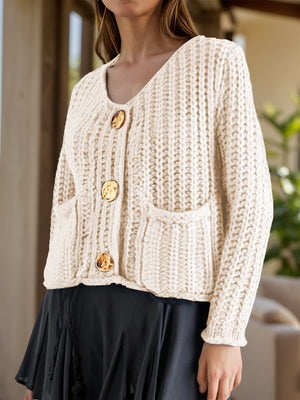 Chunky knit beige cardigan with statement buttons and pockets