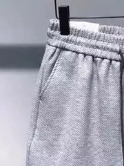 Gray drawstring boxer shorts with pockets and elastic waistband.