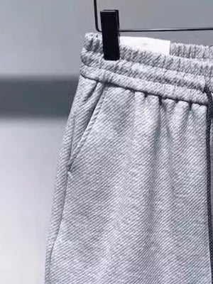 Gray drawstring boxer shorts with pockets and elastic waistband.