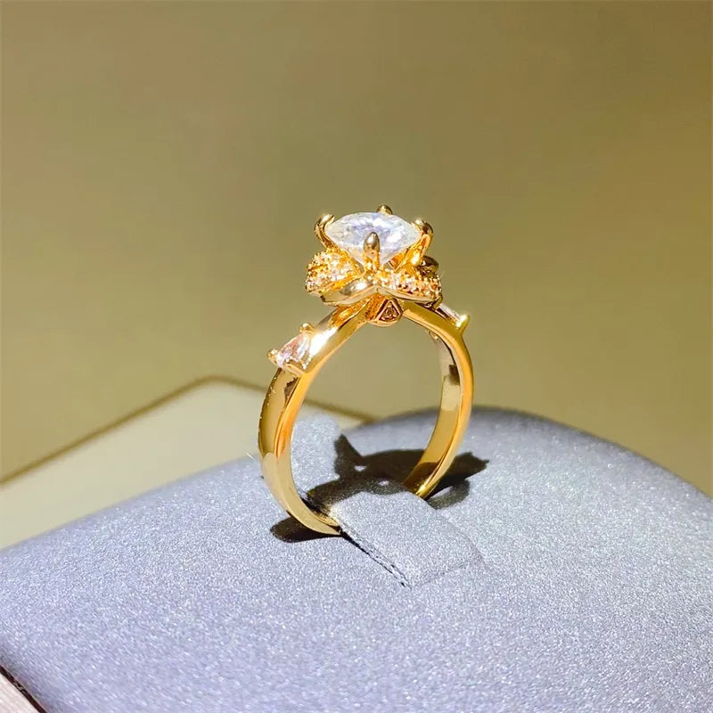 Gold statement ring with floral halo moissanite and accent stones.