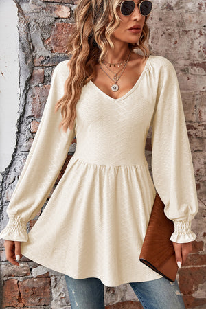 Ivory textured empire waist blouse with shirred sleeves and V-neck