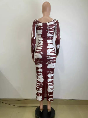 Wine red tie-dye maxi dress with long sleeves and a side slit.
