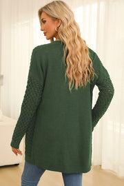 Dark green open-knit pocket cardigan with textured sleeves.
