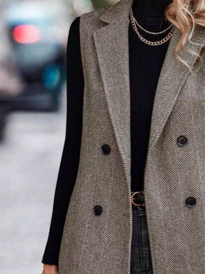 Herringbone double-breasted tailored vest in taupe with a collared neckline and buttoned front.