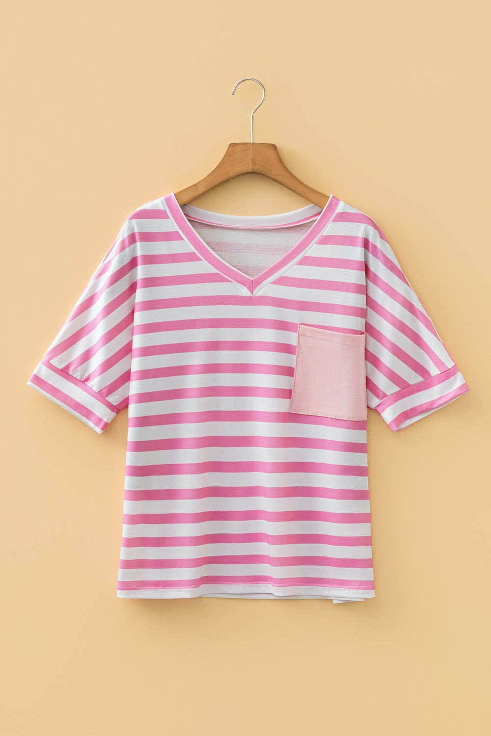 Striped v-neck t-shirt in blush pink with a chest pocket and short sleeves.
