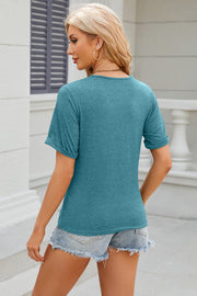 Teal asymmetric button-up tee with cuffed short sleeves and a crew neck.