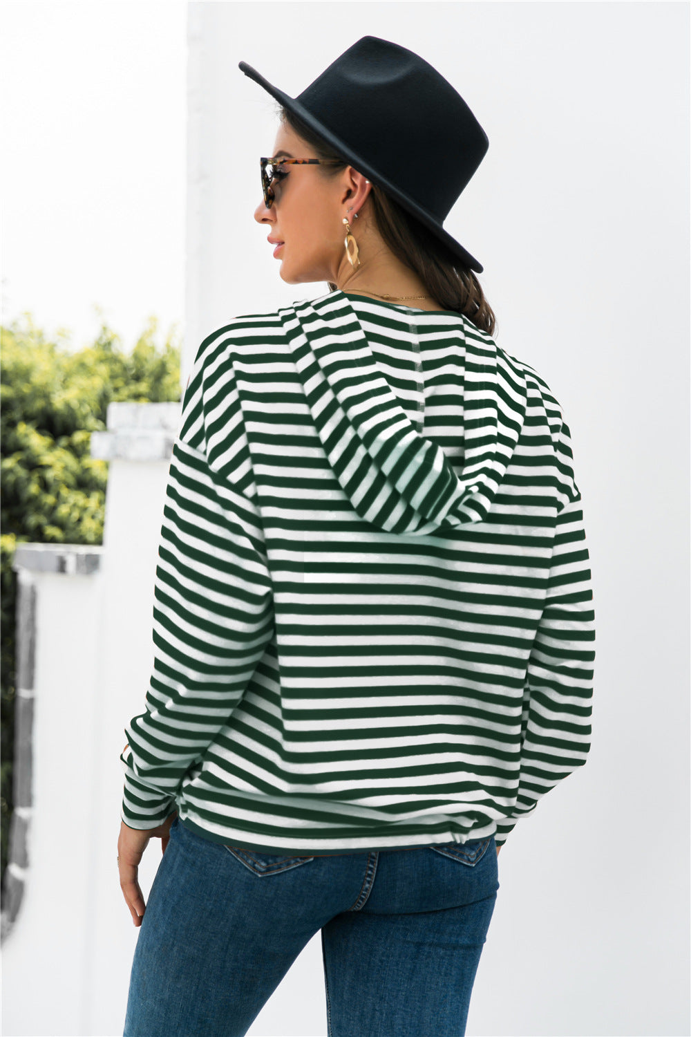 Relaxed fit hoodie in forest green and white stripes with a hood and button neck detail.