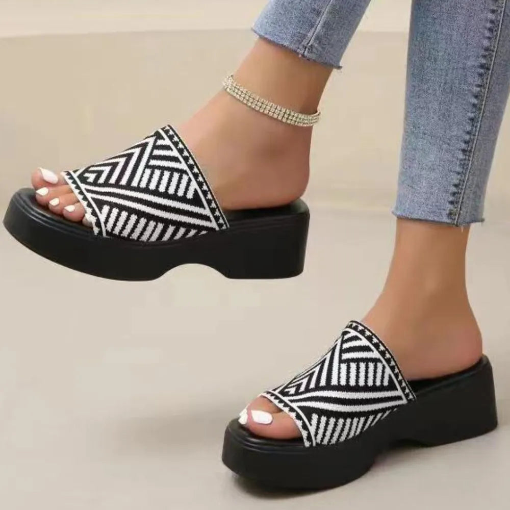 Platform knit slide sandals in black and white geometric pattern with a thick sole.