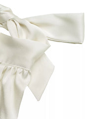Elegant cream satin tank top with gathered neckline and bow detail.