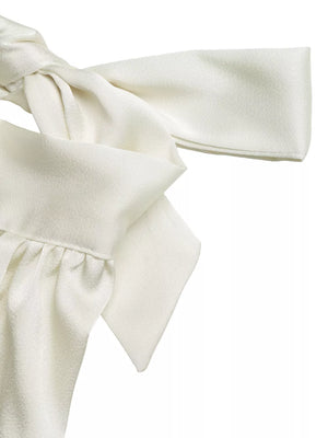 Elegant cream satin tank top with gathered neckline and bow detail.