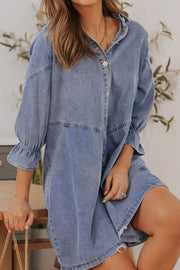 Light blue denim shirtdress with button front and ruffled cuff detail.