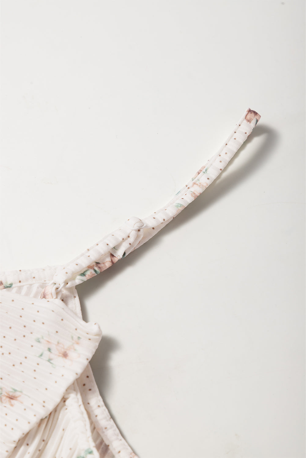 Floral print tank top with polka dots and a bow detail on the strap.