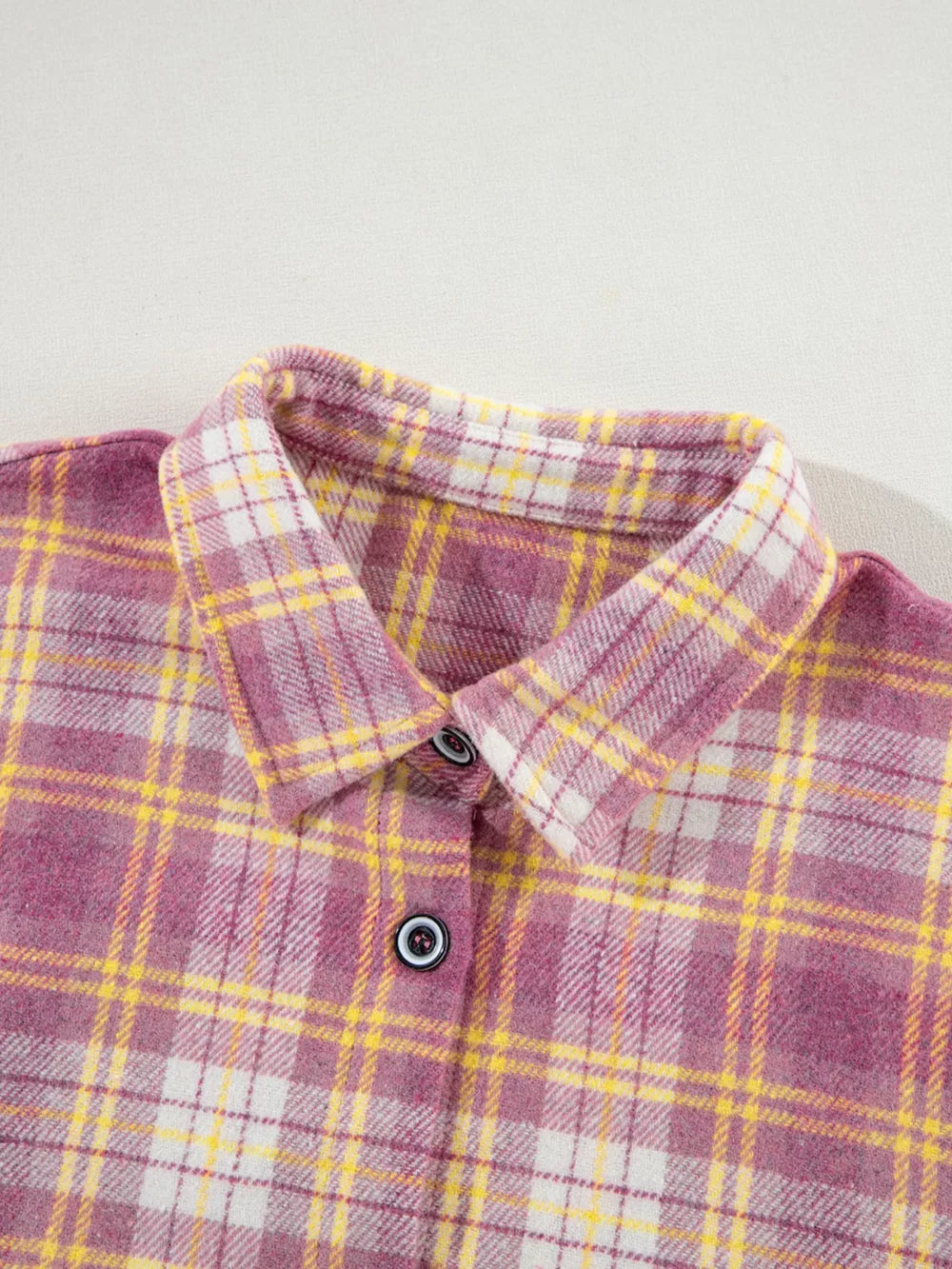 Oversized shacket with pink, yellow, and white plaid pattern, classic collar, and button-down front.