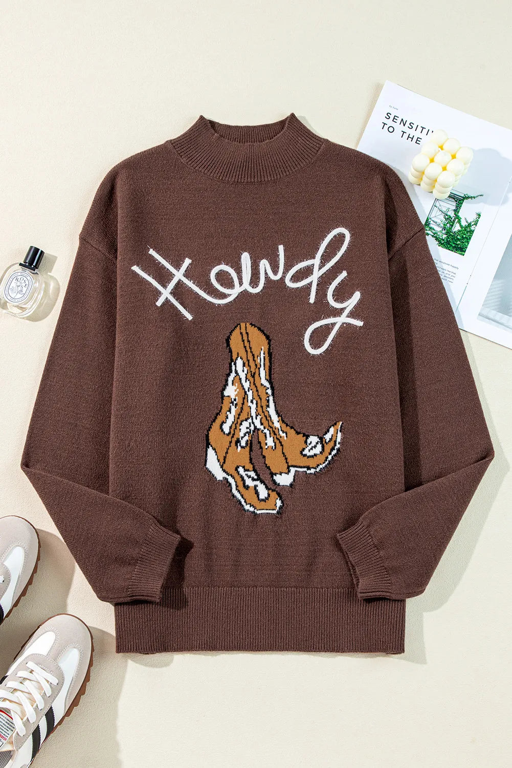 Brown mock neck sweater with white "Howdy" text and cowboy boot graphic.