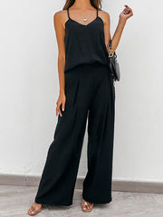 Black cami and pleated palazzo pants set with wide legs.