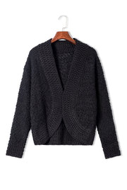 Black textured bouclé open-front jacket with a V-neck and long sleeves.