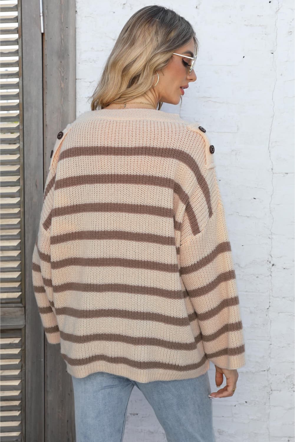 Apricot striped knit pullover sweater with button shoulder detail.