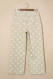 Polka dot high-waisted wide-leg jeans in beige denim with white dots and raw hem.