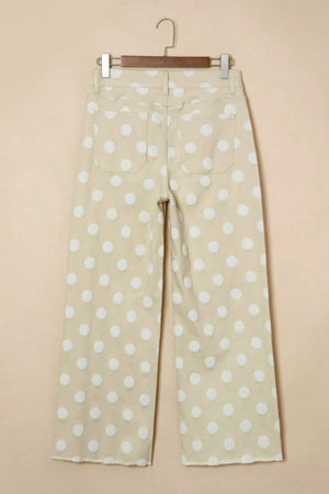 Polka dot high-waisted wide-leg jeans in beige denim with white dots and raw hem.