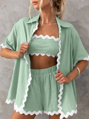 Scalloped edge linen shirt set in gum leaf green with white trim, featuring a button-down shirt, bandeau top, and shorts.