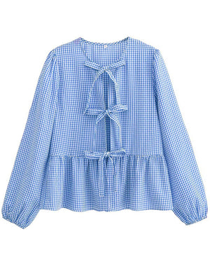 Light blue gingham tie-front peplum blouse with voluminous sleeves and bow details.