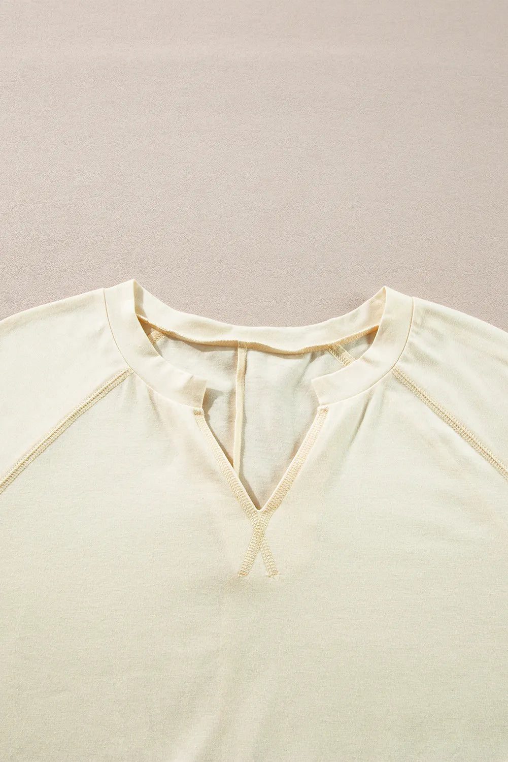 Gathered Sleeve V-Neck Top in pastel yellow with contrast stitching detail.