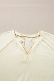 Gathered Sleeve V-Neck Top in pastel yellow with contrast stitching detail.
