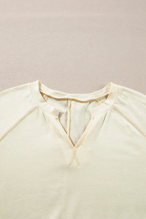 Gathered Sleeve V-Neck Top in pastel yellow with contrast stitching detail.