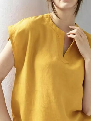 Yellow cap sleeve shirt with notched neckline and casual fit.