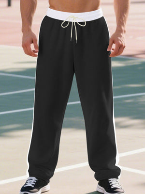 Men's black wide-leg sweatpants with white side stripes and drawstring waist