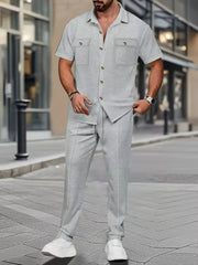 Men's gray two-piece casual set with short-sleeve button-up shirt and drawstring pants.