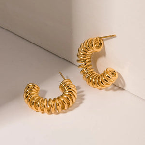 Gold vermeil spiral coil hoop earrings with a textured finish.