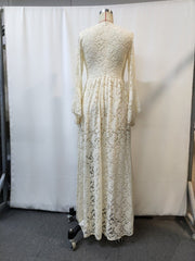 Cream lace maxi dress with long bell sleeves and a high neckline, shown from the back.