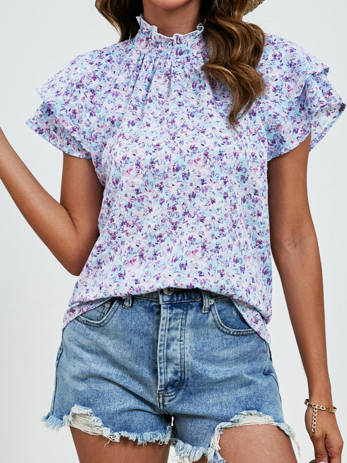 Light blue floral blouse with ruffled neckline and flutter sleeves