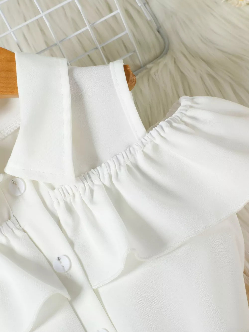 Toddler ruffled cold-shoulder top with button detail and collar.