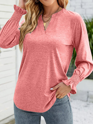 Burnt coral jersey v-neck top with gathered cuff long sleeves.