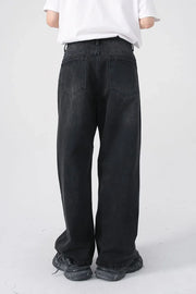 Black denim jeans with a relaxed fit and two back pockets.