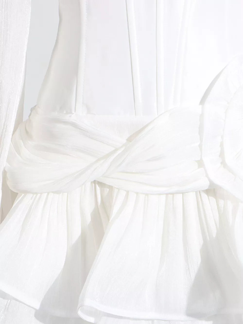 White ruffle mini dress with twisted waist detail and balloon sleeves