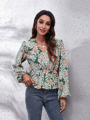 Green tropical print peplum blouse with balloon sleeves and V-neck.