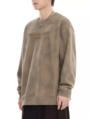 Oversized Dune Yellow sweatshirt with embroidered text, crewneck, and long sleeves.