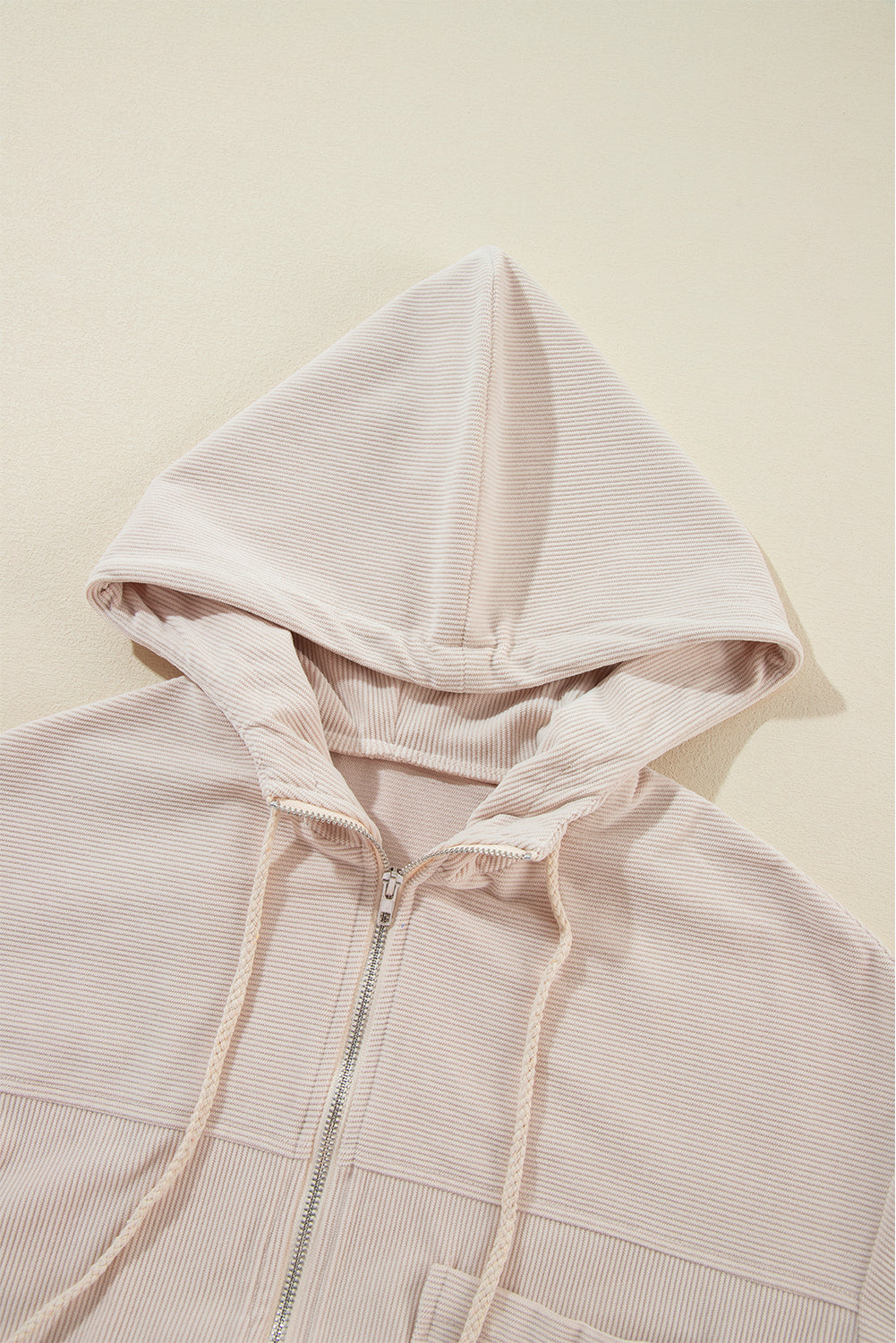 Cream corduroy bomber hoodie with zipper and drawstring hood detail