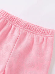 Pink baby leggings with embossed floral pattern and elastic waistband